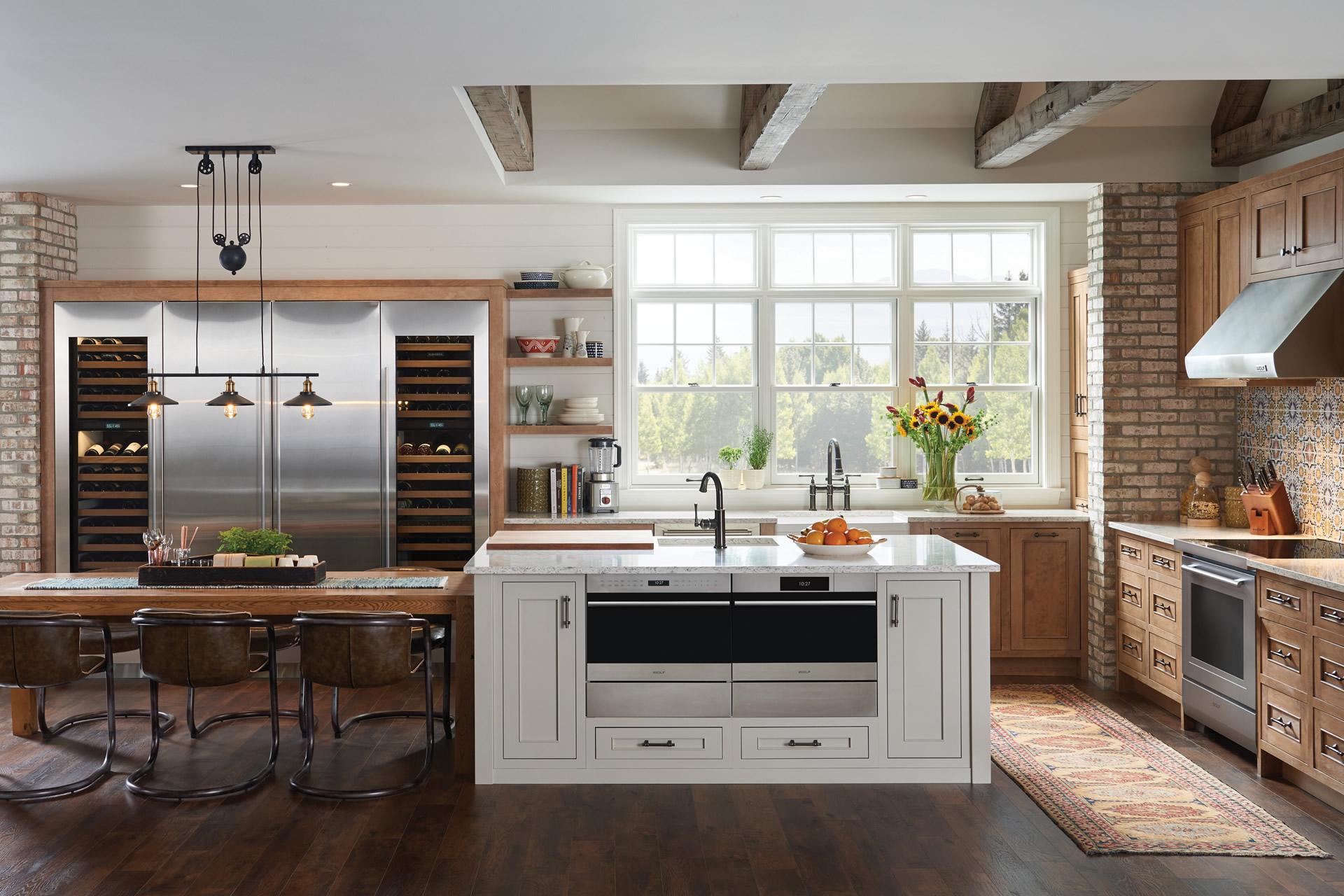 Luxury kitchen featuring specialty appliances including built-in wine refrigerators, dual dishwashers, and premium cooking equipment in a custom-designed space.