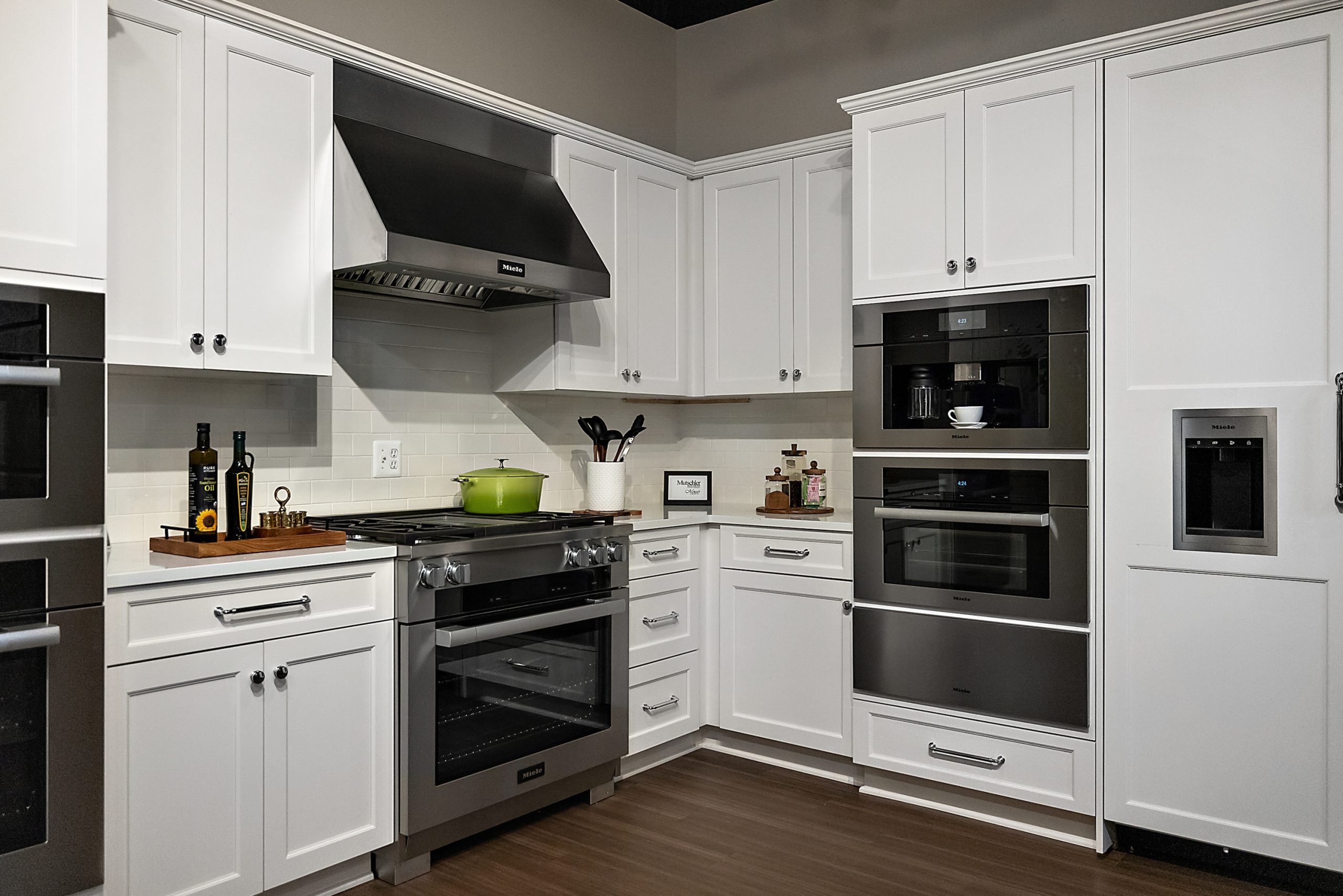 Transitional white kitchen featuring double wall ovens and gas range