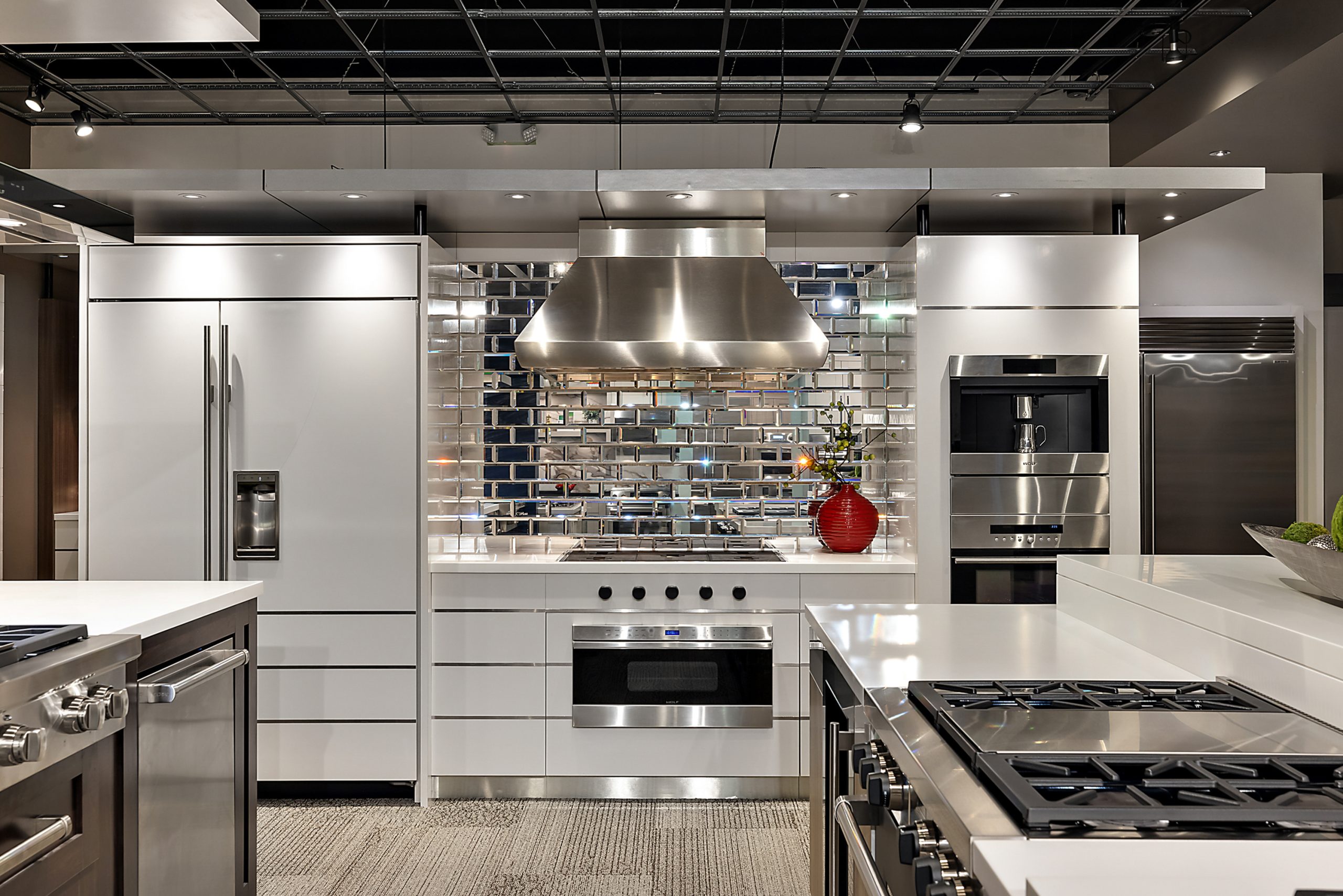 High-end kitchen design in appliance showroom with tile backsplash and professional rang